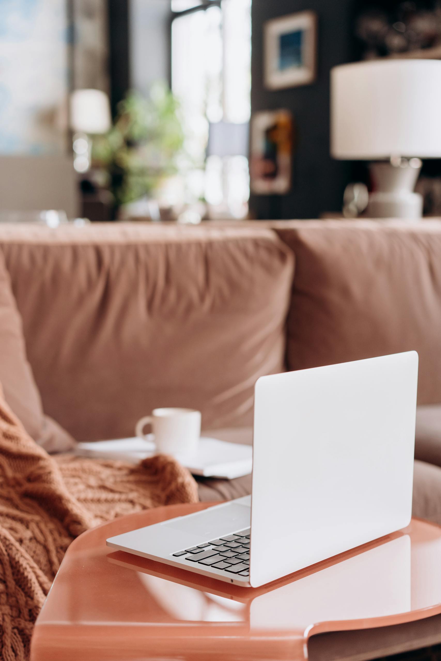 A stylish living room setup with a laptop on a table, perfect for home office inspiration.