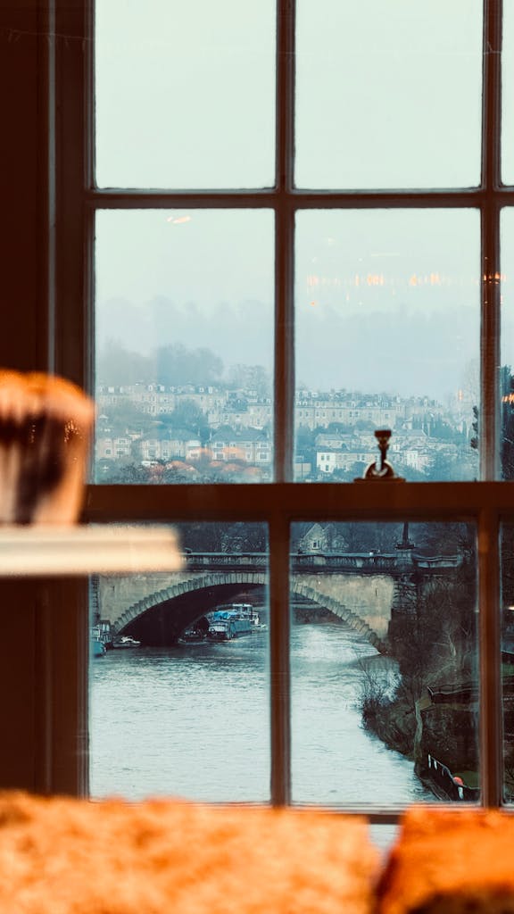 Cozy window view over River Avon and historic bridge in Bath, England. Perfect for travel inspiration.
